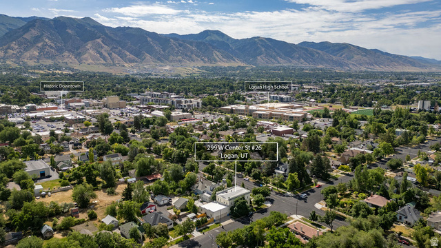 299 West Center Street, Unit 2 Logan, UT 84321 - Photo 41 of 46 Aerial perspective showcasing a residential area with varied architecture, mature trees, and mountainous terrain