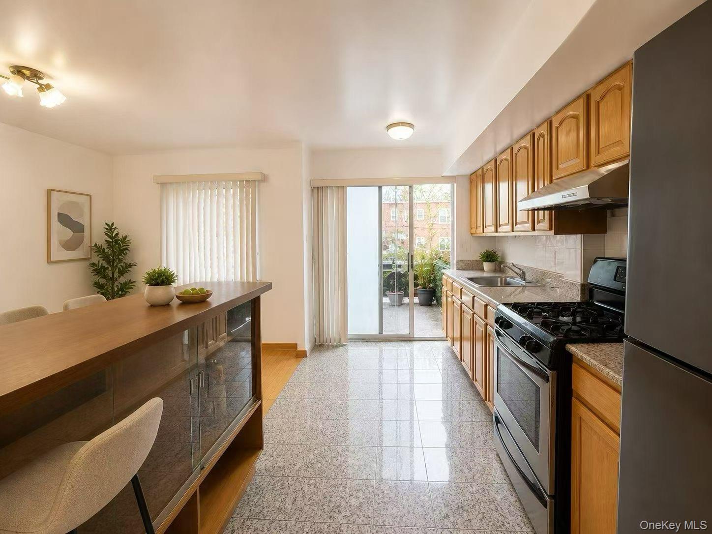 75-01 167th Street Queens, NY 11366 - Photo 5 of 10 a large kitchen with stainless steel appliances granite countertop a stove and a sink