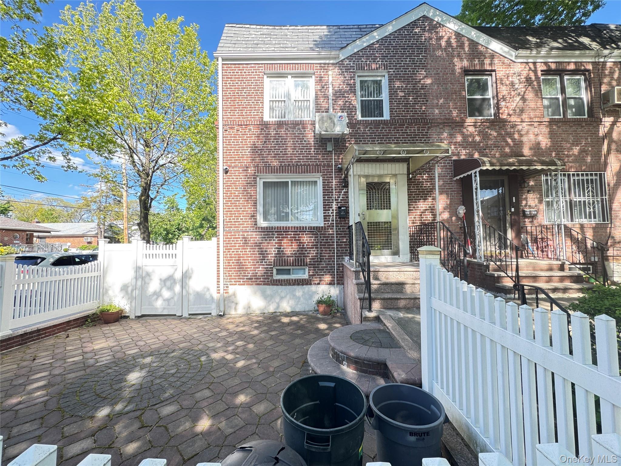 75-01 167th Street Queens, NY 11366 - Photo 9 of 10 a front view of a house with yard and seating area