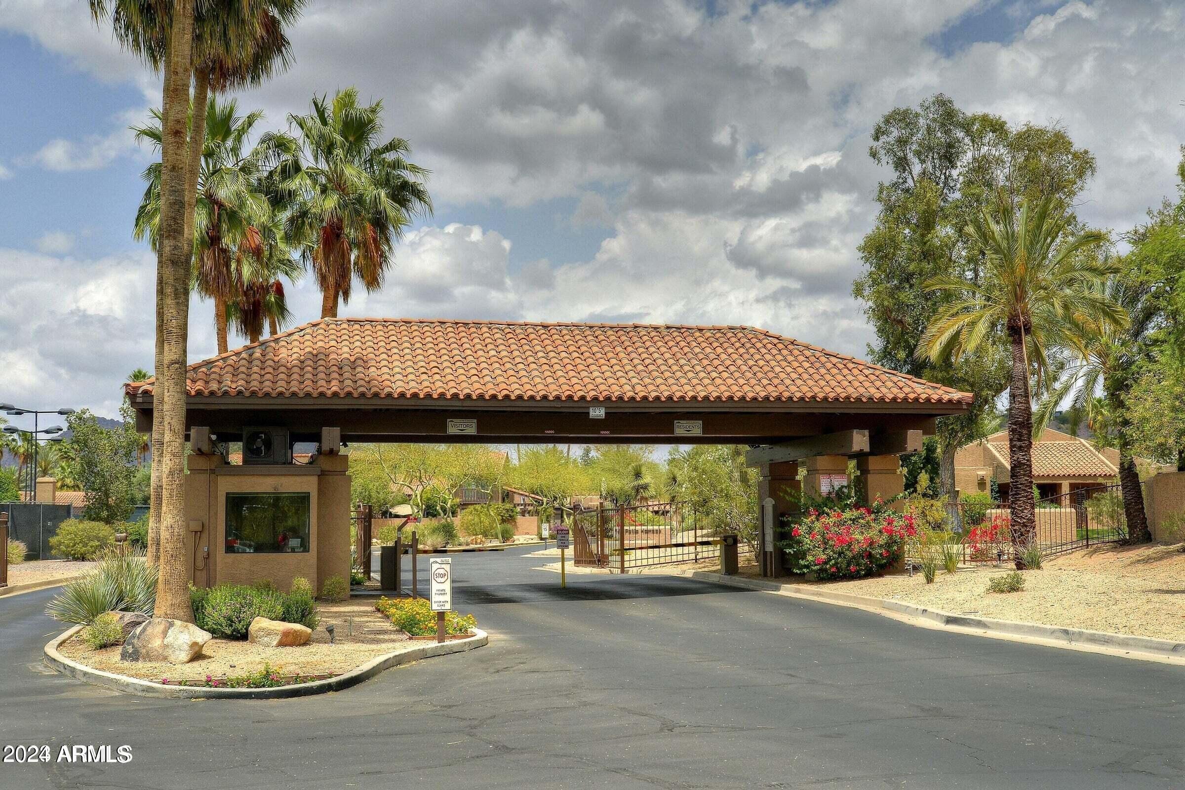 4440 East Camelback Road, Unit 32 Phoenix, AZ 85018 - Photo 2 of 7 a view of a patio with table and chairs under an umbrella
