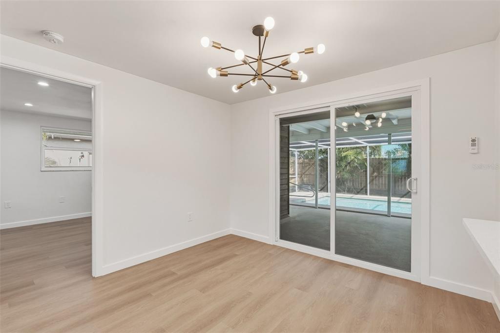 1330 Horizon Road Venice, FL 34293 - Photo 17 of 40 an empty room with wooden floor fan and windows