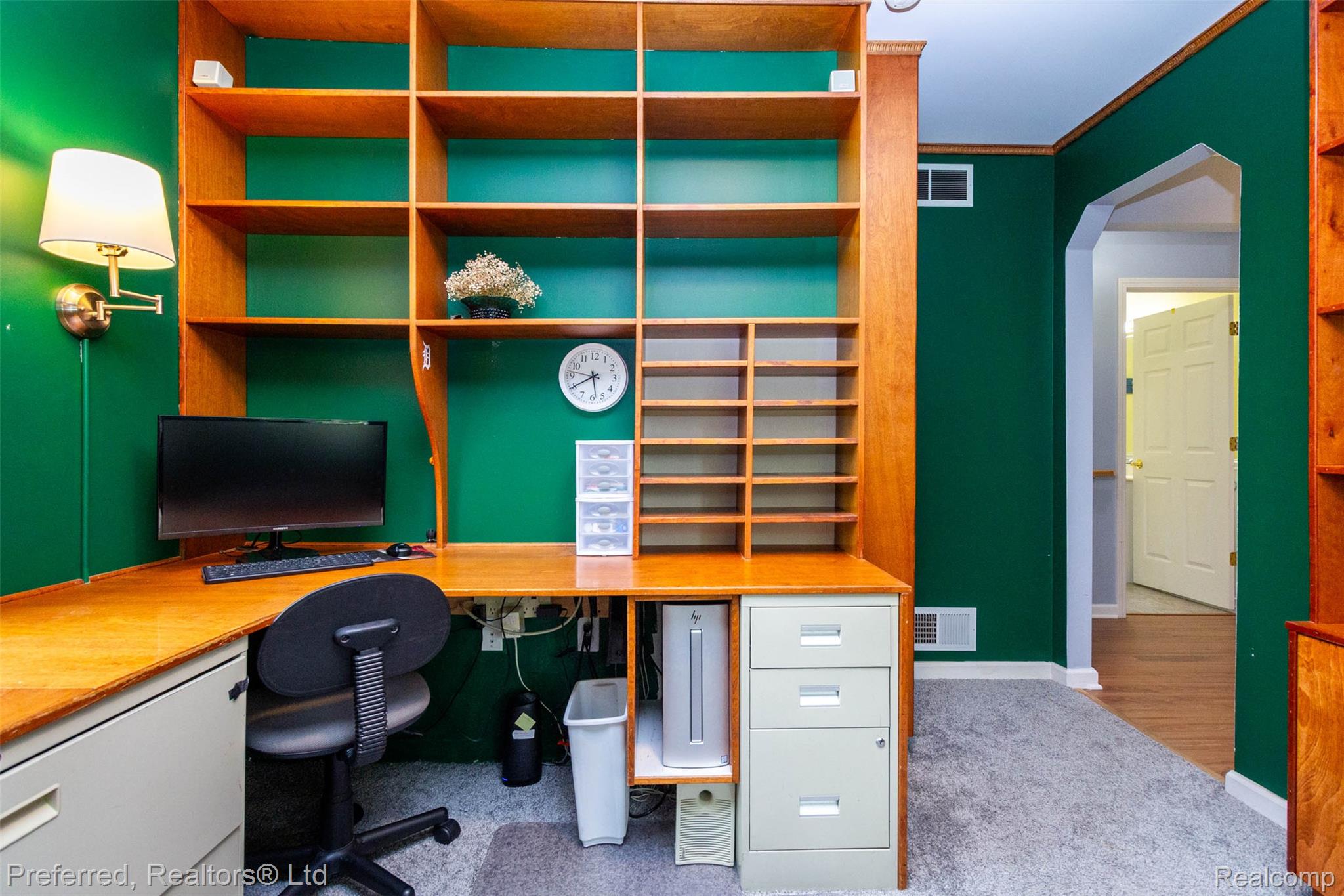9840 Currie Road Northville, MI 48167 - Photo 32 of 62 Home office featuring arched walkways, light colored carpet, ornamental molding, and built in desk