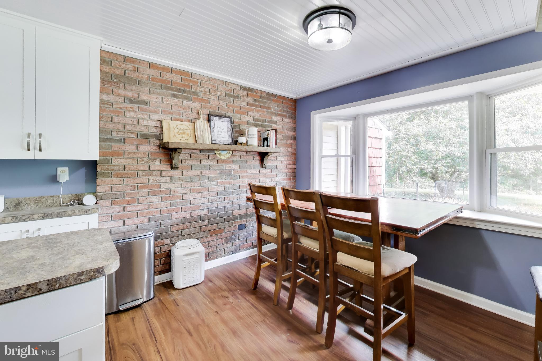 3240 Juniper Lane Huntingtown, MD 20639 - Photo 7 of 48 a view of a dining room with furniture window and wooden floor
