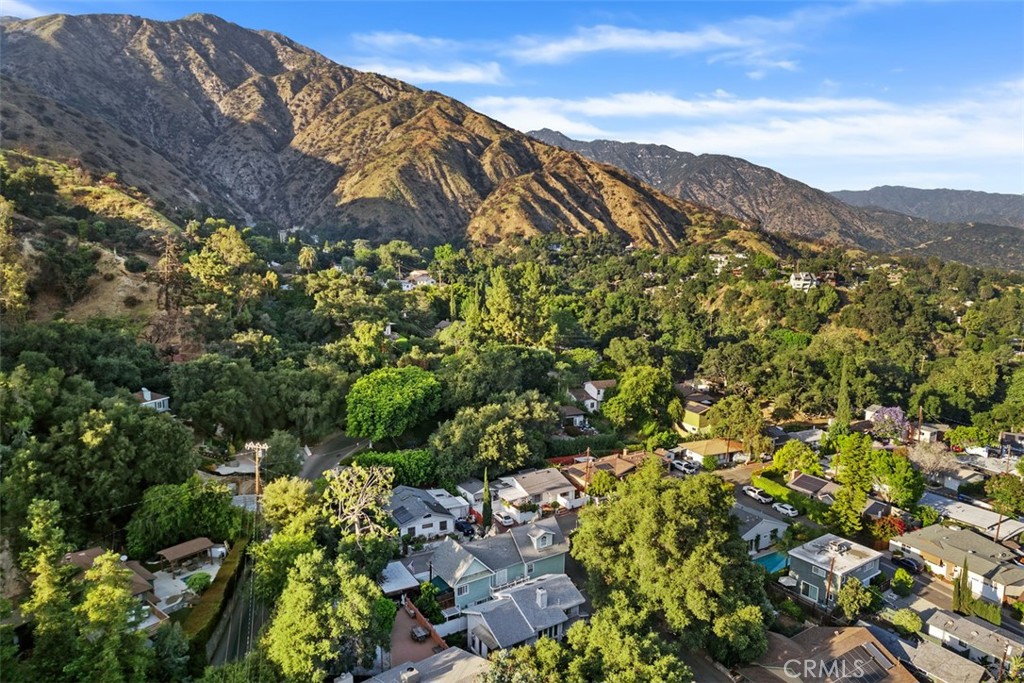 a view of a houses with a lush green hillside