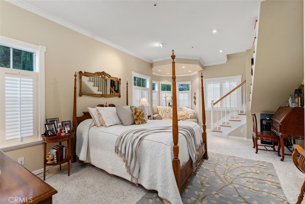 315 Old Ranch Road Sierra Madre, CA 91024 - Photo 17 of 42 a bedroom with a bed and a chandelier