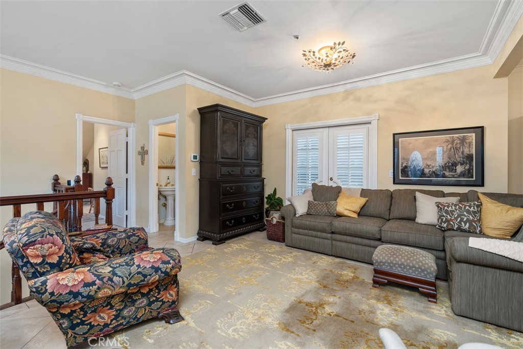 315 Old Ranch Road Sierra Madre, CA 91024 - Photo 9 of 42 a living room with furniture stairs and a chandelier
