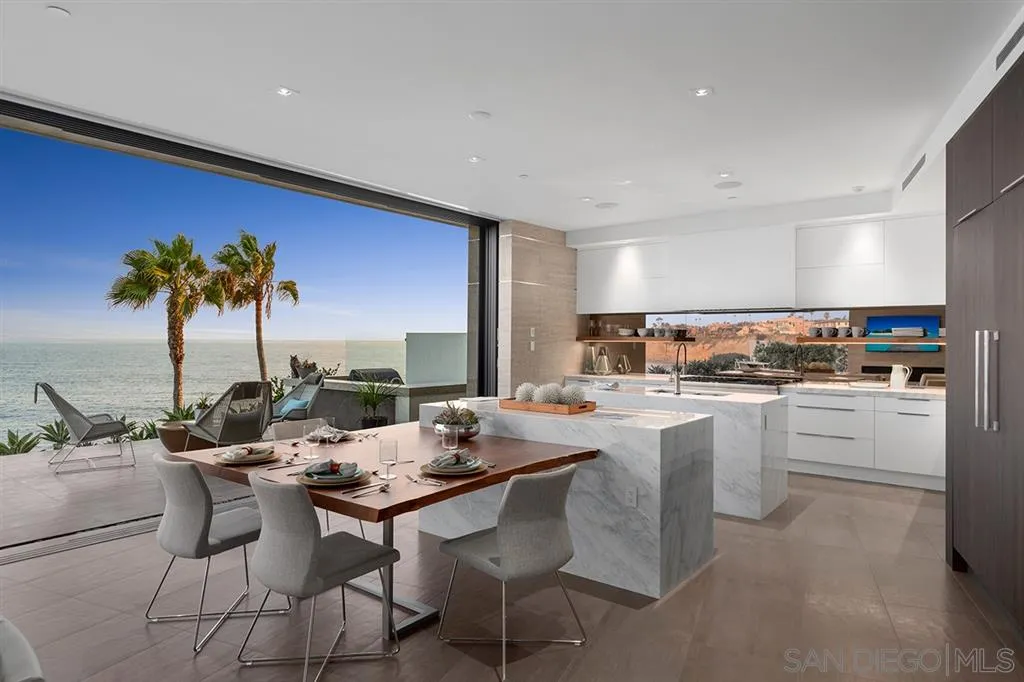 311 Sea Ridge Drive La Jolla, CA 92037 - Photo 5 of 25 a kitchen with a table chairs stove and cabinets