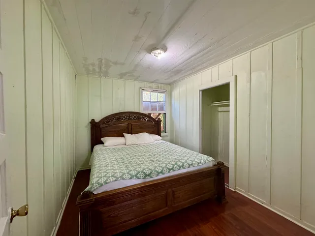 a bedroom with a bed and a mirror