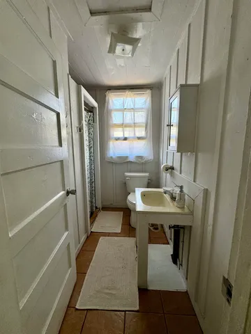 a view of a bathroom with tub and sink