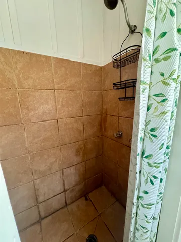 a view of a kitchen with cabinets and wooden floor