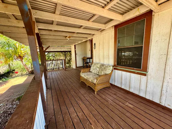 a balcony with furniture and a potted plant