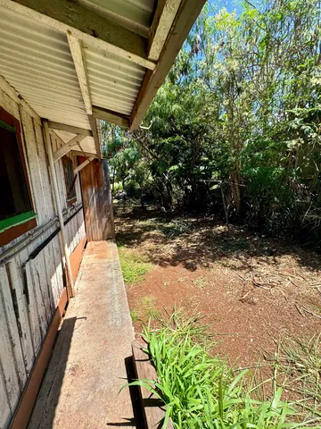 a view of empty room with wooden ceiling
