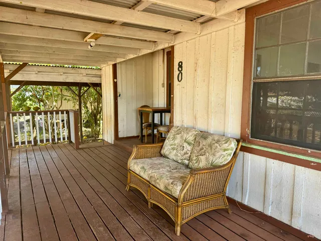 a living room with wooden floor furniture and a window
