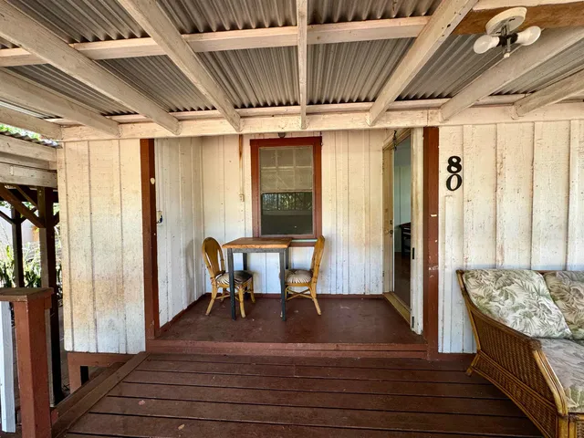 a view of dining room with wooden floor and furniture