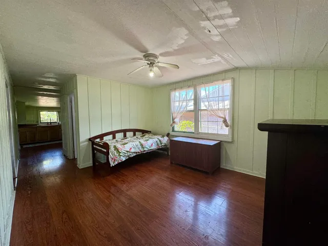 a spacious bedroom with a bed and a window