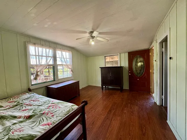 a bedroom with a bed closet and a window