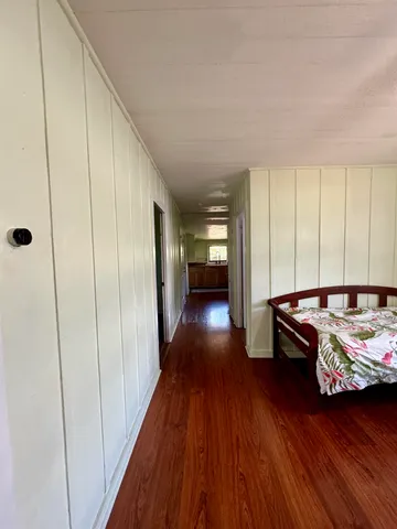 a view of a livingroom with wooden floor and furniture