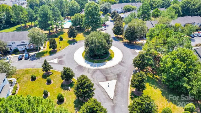 an aerial view of a house with swimming pool and garden