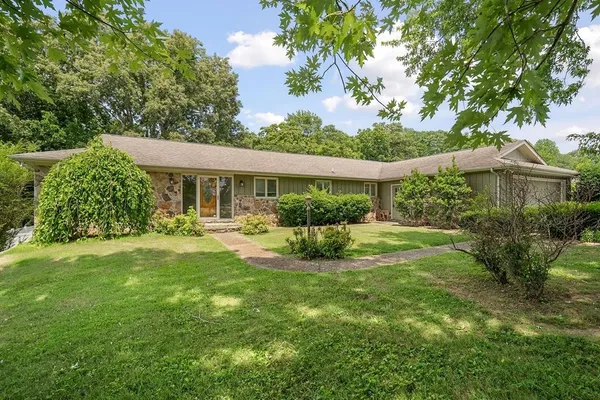 a view of a house with a yard porch and sitting area