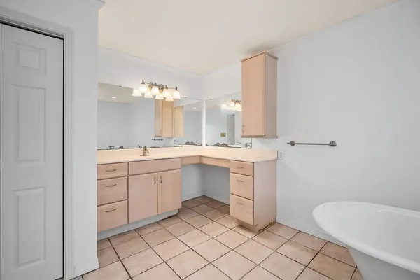 a spacious bathroom with a double vanity sink mirror and toilet