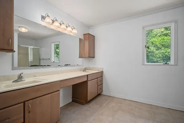 a bathroom with a double vanity sink and mirror