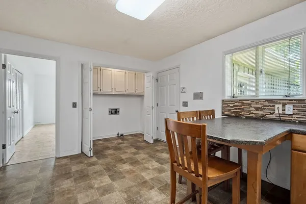 a view of kitchen with granite countertop window and wooden floor