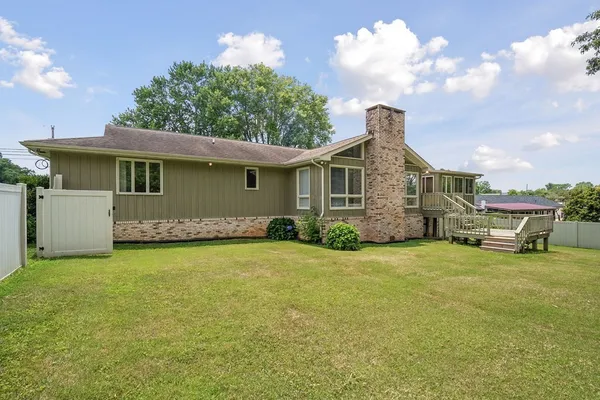 a front view of a house with a garden and road