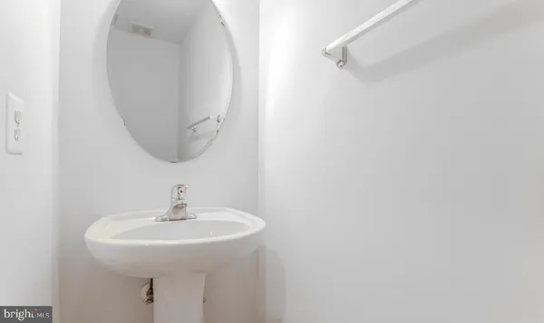 a bathroom with a tub a sink and a large mirror