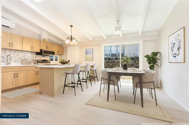 a kitchen with kitchen island a sink stainless steel appliances and cabinets