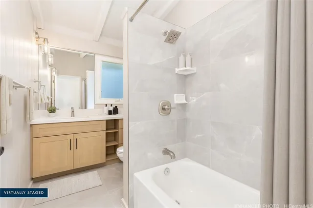 a bathroom with a bathtub sink a mirror and a shower