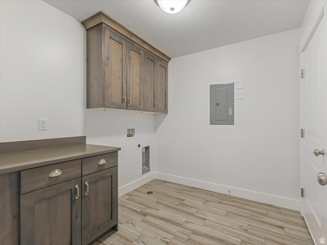 1278 South Grace Way Layton, UT 84041 - Photo 9 of 23 Dedicated laundry space featuring wood-finish cabinetry, a coordinating countertop, and plank-style flooring