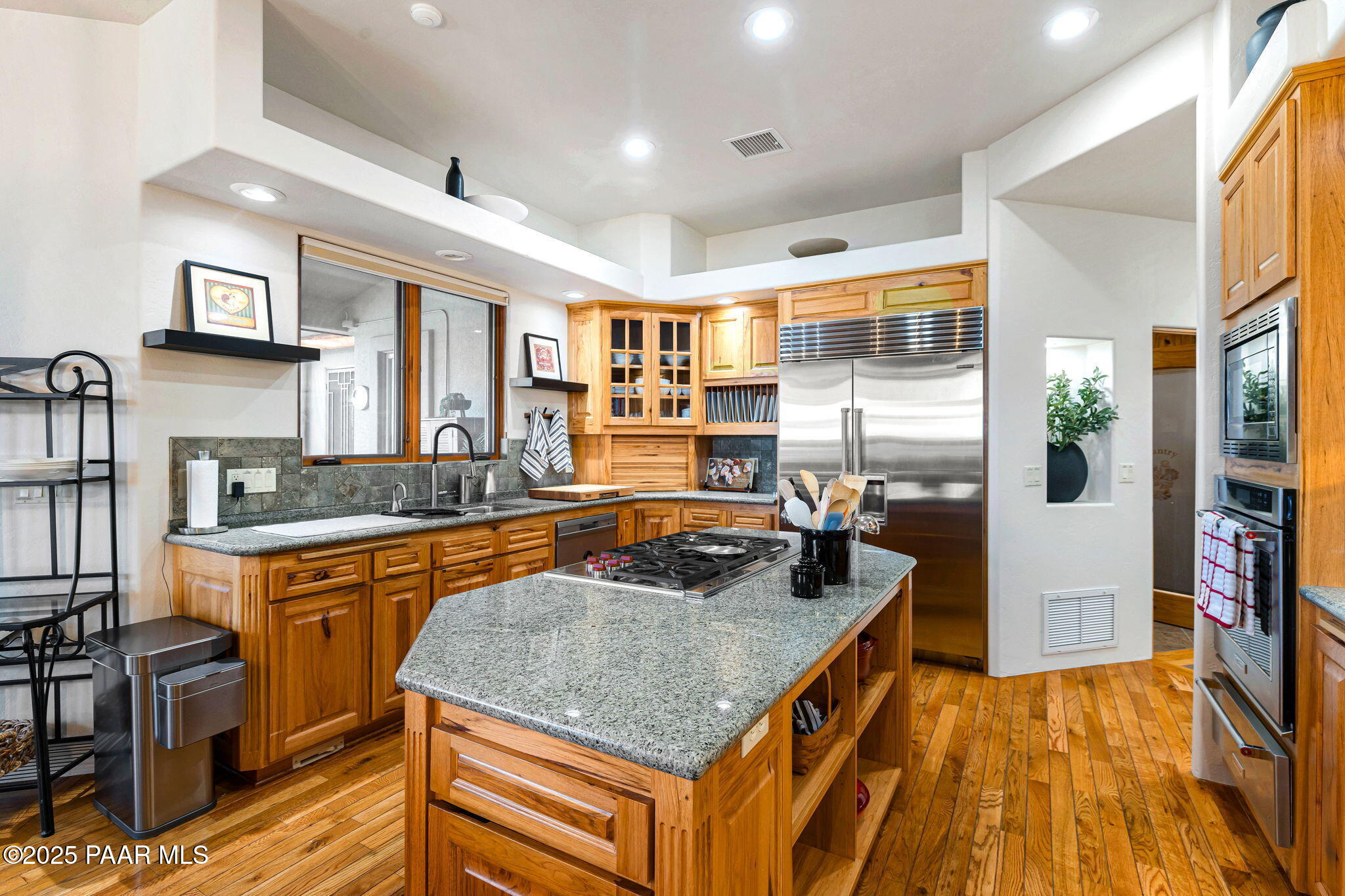 13995 North Thunderbird Road, Unit 74 Prescott, AZ 86305 - Photo 17 of 63 a kitchen with stainless steel appliances granite countertop a sink and a refrigerator