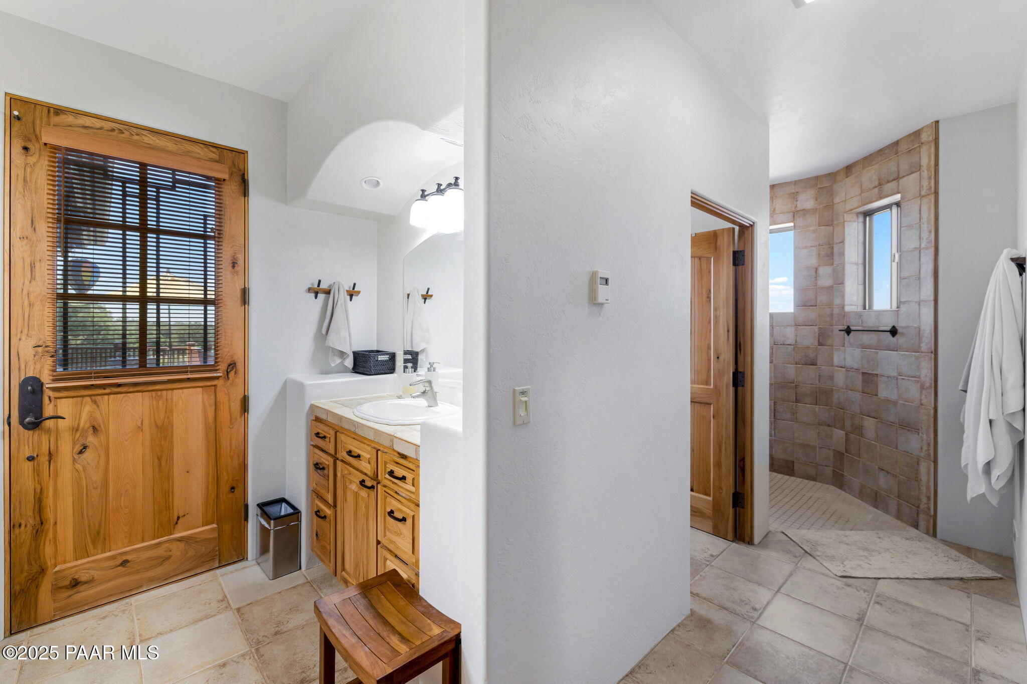 13995 North Thunderbird Road, Unit 74 Prescott, AZ 86305 - Photo 29 of 63 a bathroom with a sink a mirror and a shower