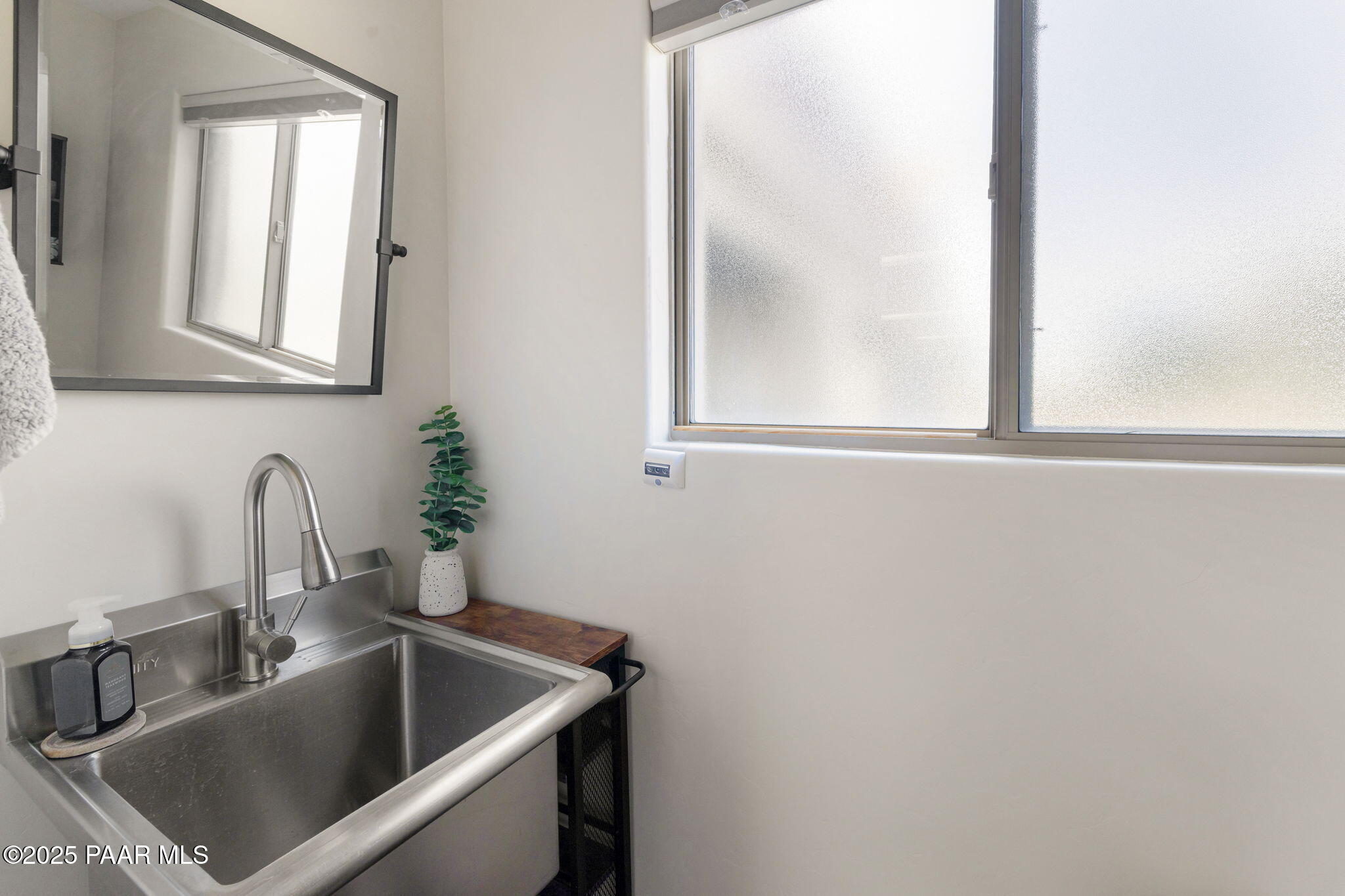 13995 North Thunderbird Road, Unit 74 Prescott, AZ 86305 - Photo 54 of 63 a bathroom with mirror sink and window