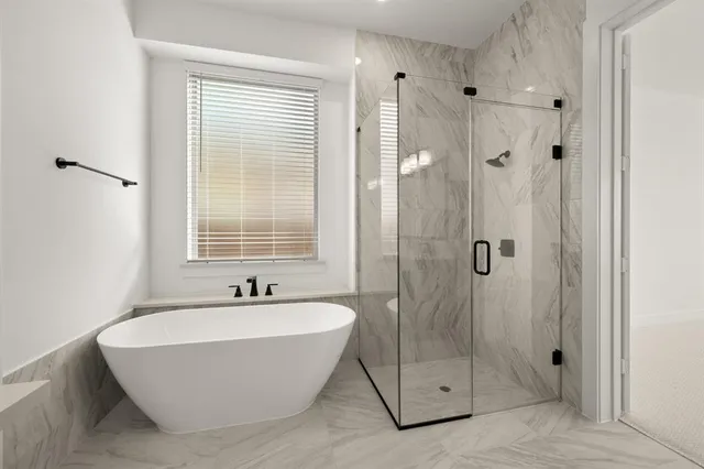 a bathroom with a bathtub and shower