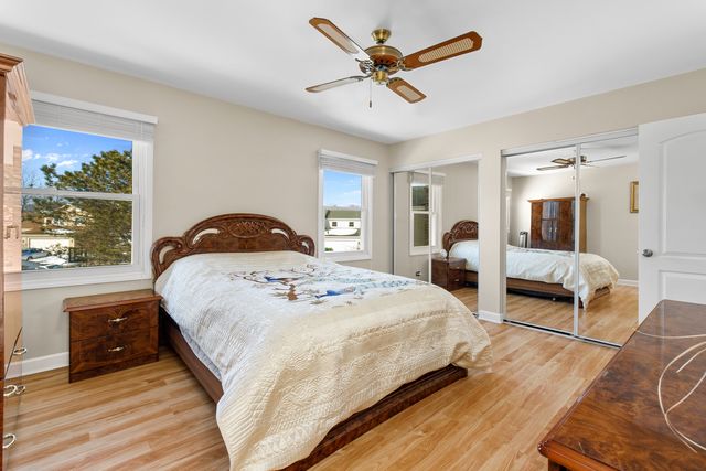 a bedroom with a bed and a large mirror