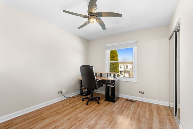 a view of a workspace with furniture and a window