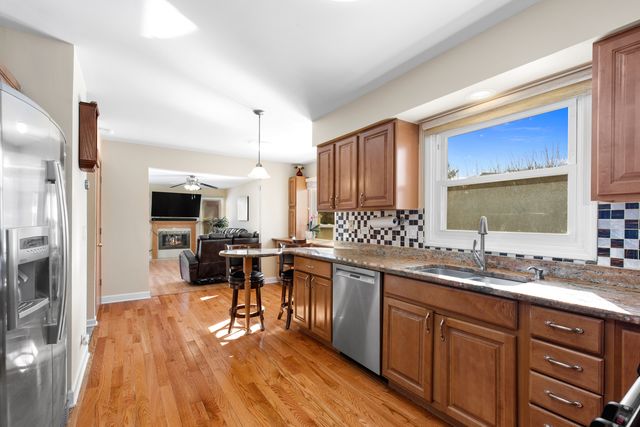 a kitchen with a sink stove and wooden cabinets