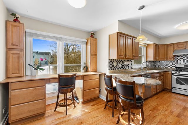 a kitchen with a table chairs stove and cabinets
