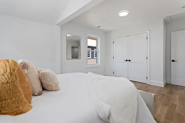 a bedroom with a bed and a window