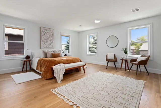 a bedroom with a bed a table and chair