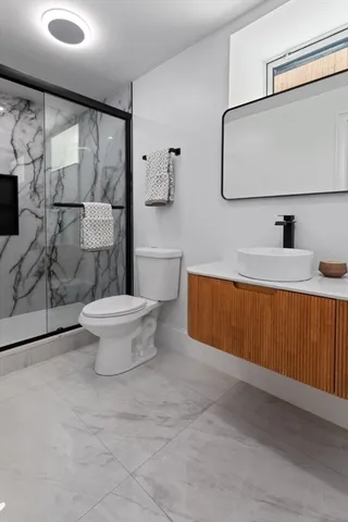 a bathroom with a sink toilet and shower