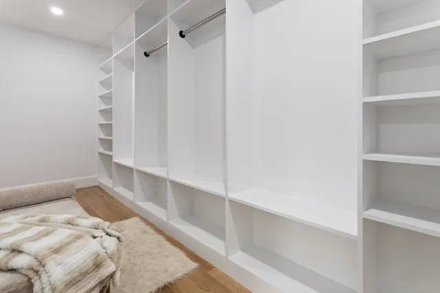 a view of walk in closet with empty racks
