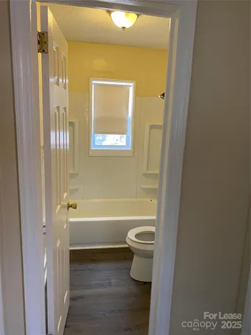 a bathroom with a toilet a sink and bathtub