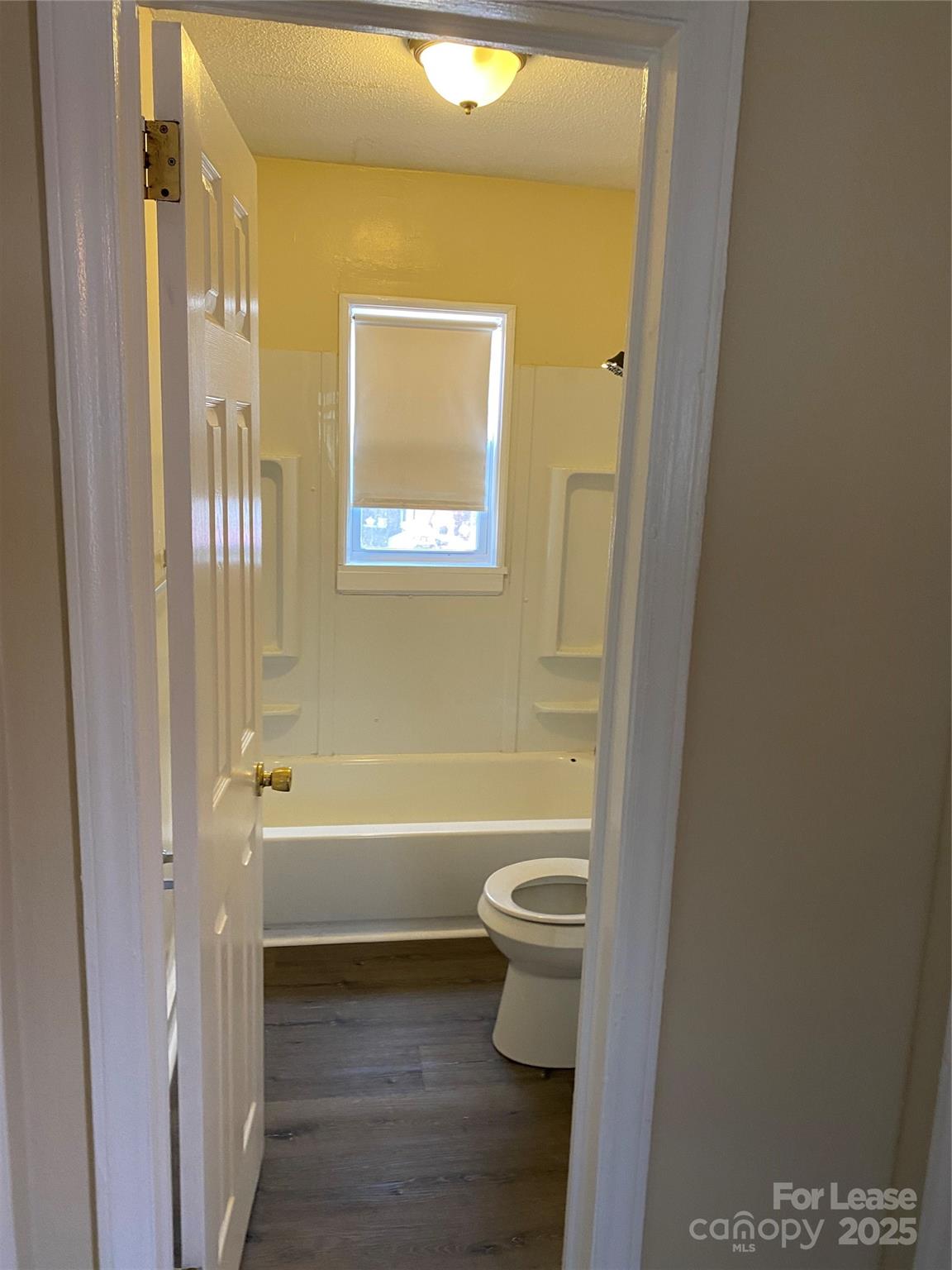 3100 Zircon Street, Unit 1 Charlotte, NC 28205 - Photo 4 of 7 a bathroom with a toilet a sink and bathtub