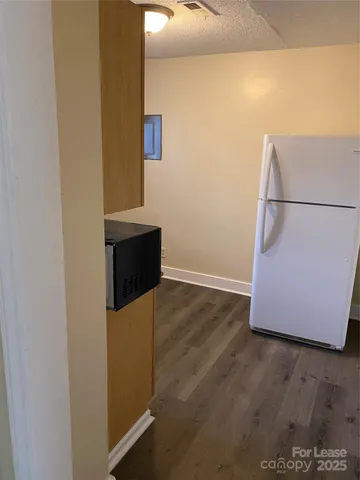 a utility room with wooden floor