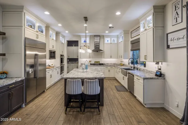 a kitchen with granite countertop a sink stove and refrigerator