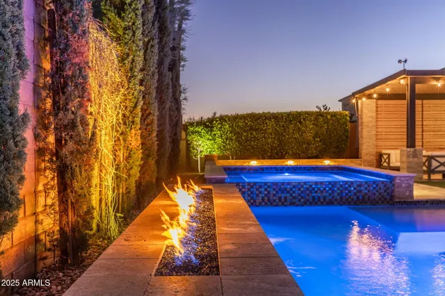 a swimming pool with glass top table and chairs