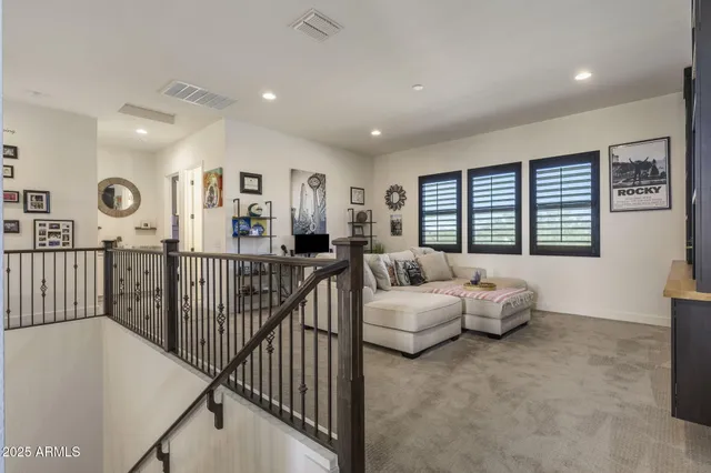 a view of empty room with wooden floor and a window