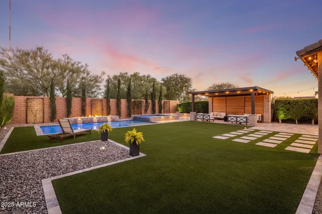 a view of a house with swimming pool and sitting area